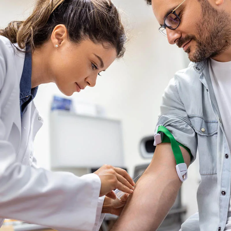 a nurse having blood sample of male